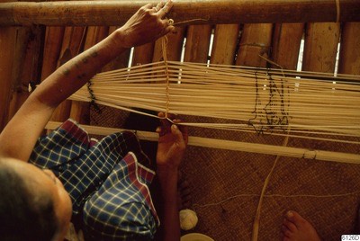 Hands at heddle sticks