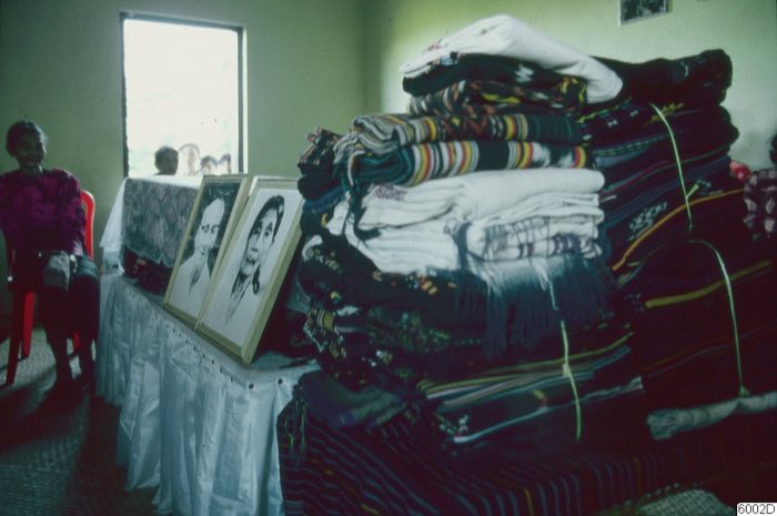 Stacked textiles at burial preparations